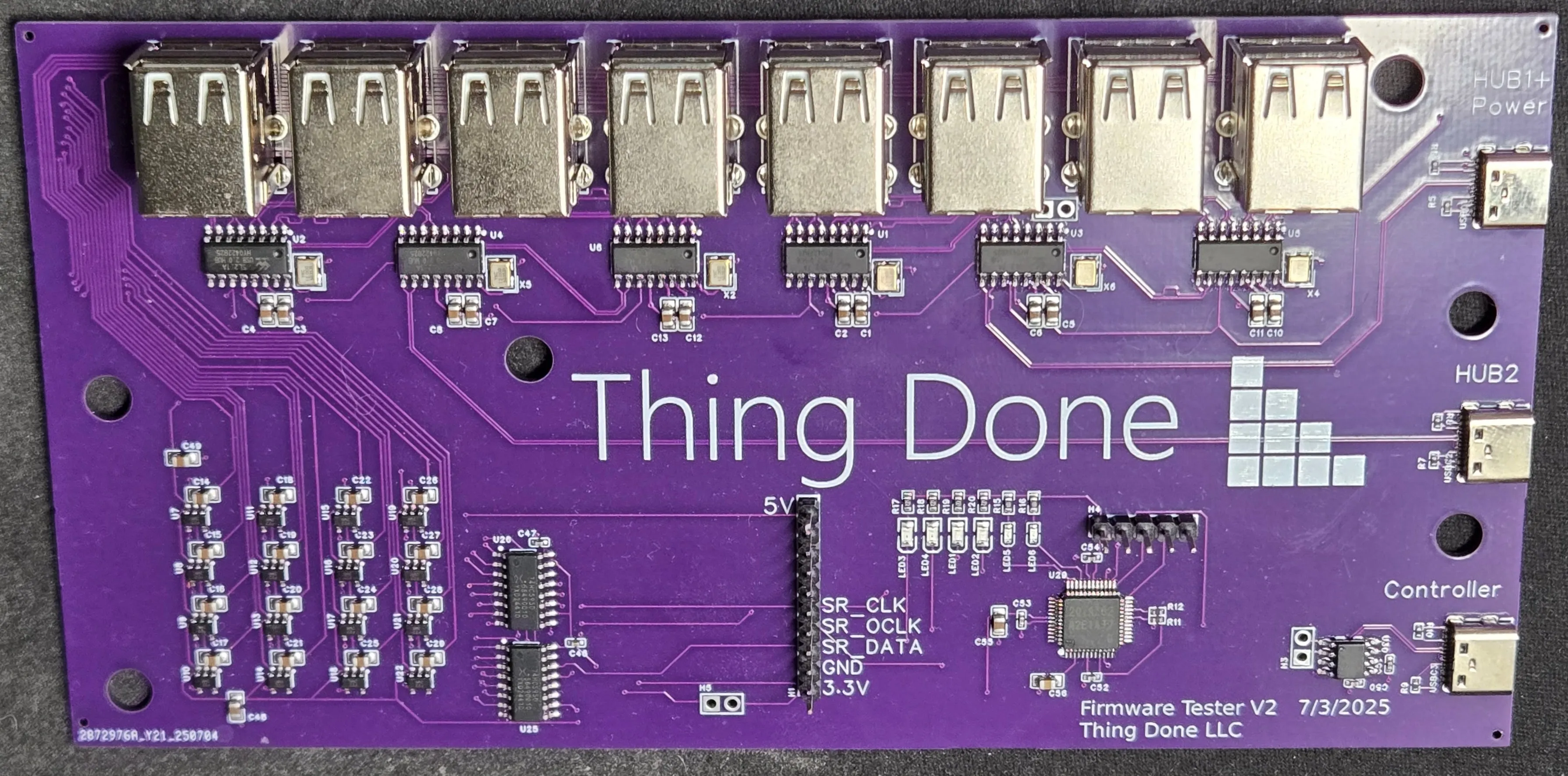 Purple PCB with THING DONE printed on it and sixteen USB ports along the edge